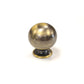 Antique aged brass spherical ball drawer knob with hand-burnished dark patina finish on a white background