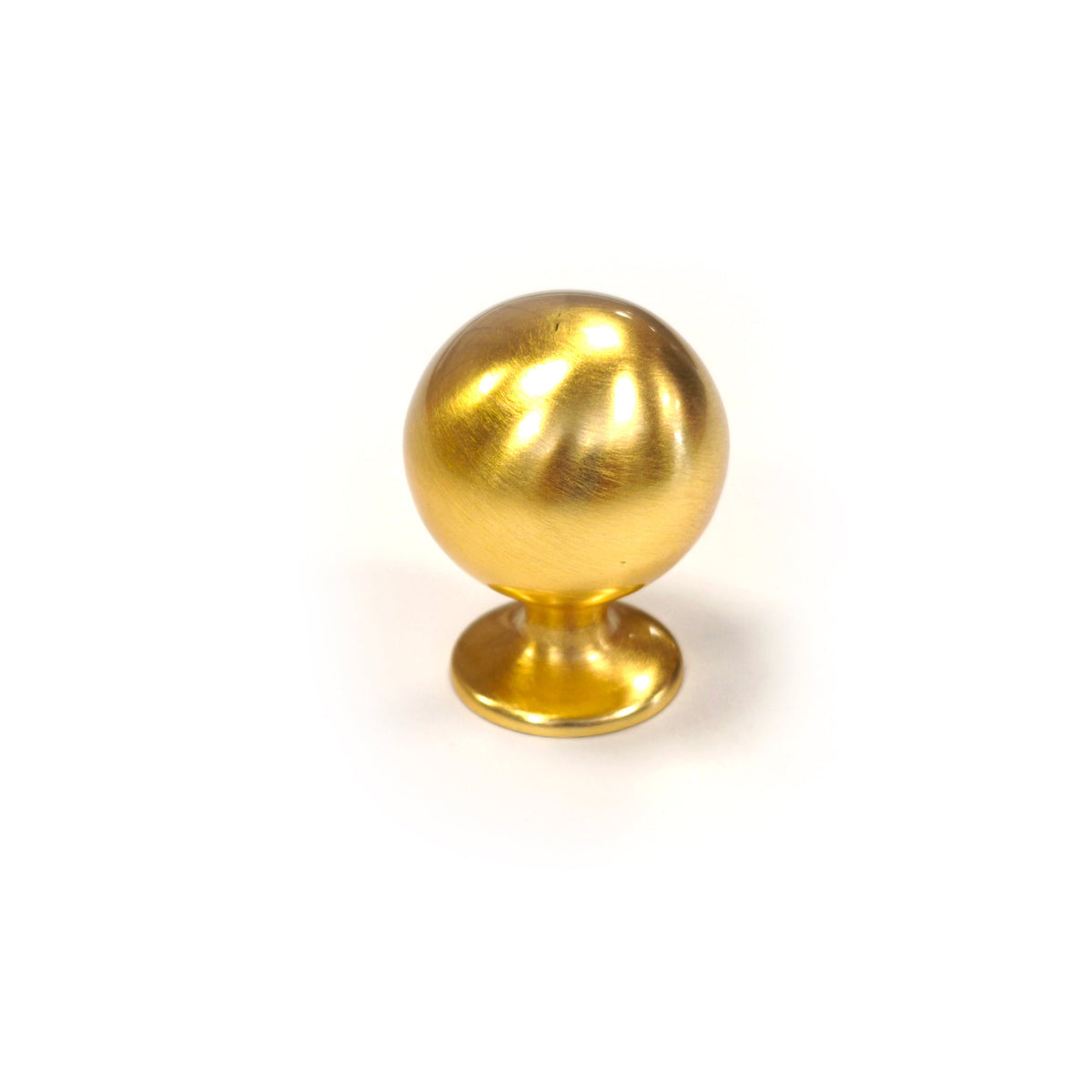 Brushed satin gold solid brass spherical ball drawer knob isolated on a white background.