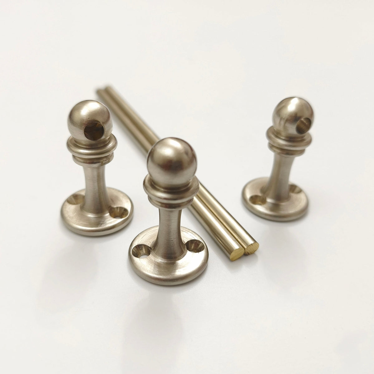 Handcrafted brushed nickel solid brass gallery rail system components including end post, corner post, through post, and rods on white background.