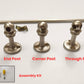 Brushed nickel gallery rail components showing end post, corner post, through post types, mounting screws, and assembly kit.