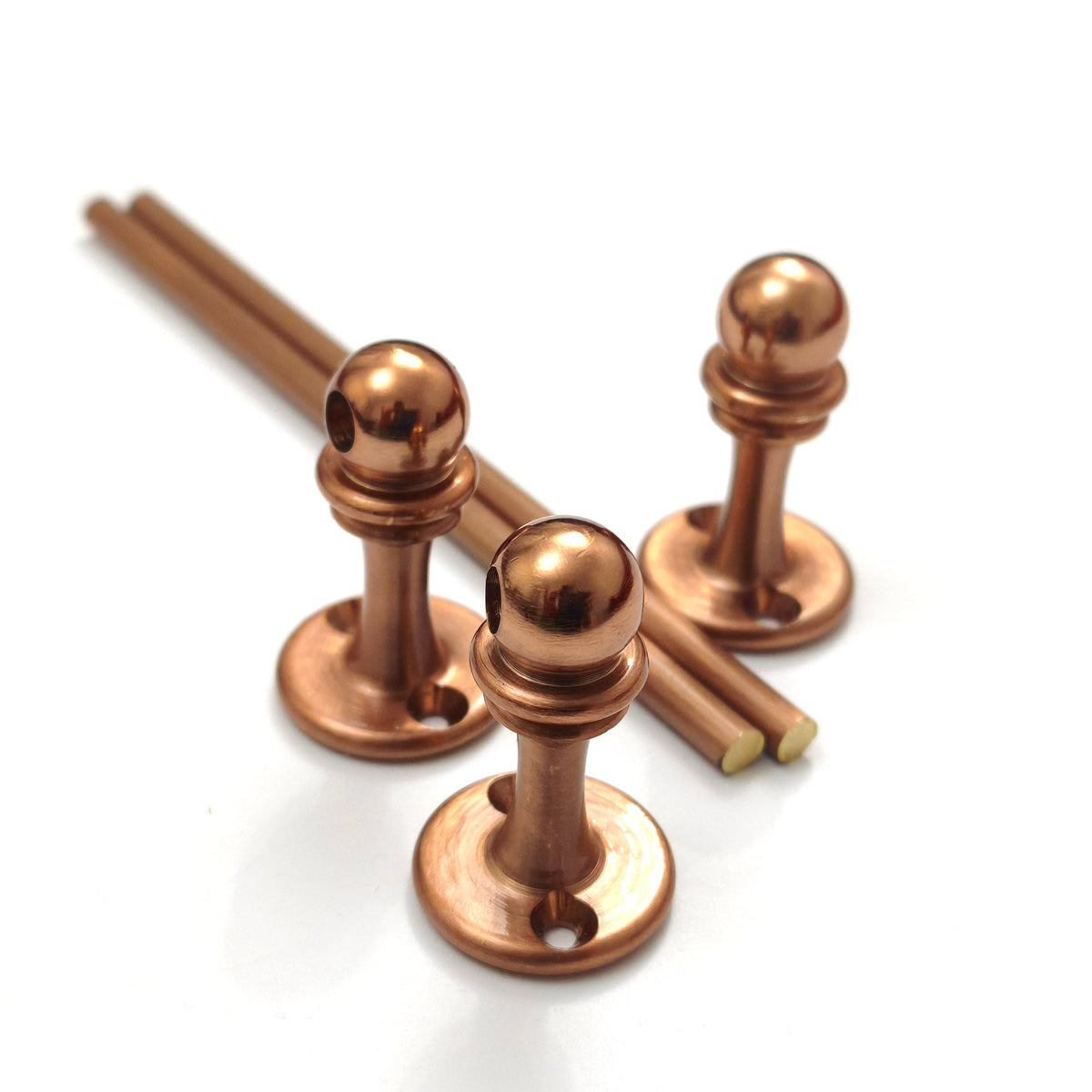 Brass Gallery Rail solid brass gallery rail components in a warm copper finish, featuring three mounting posts and two rods. Close-up view showing the genuine solid brass core at the cut ends. – view 2