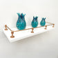 Brass Gallery Rail solid brass gallery rail set with warm copper finish, styled on a white wall shelf with turquoise decorative ceramic vases. – view 3